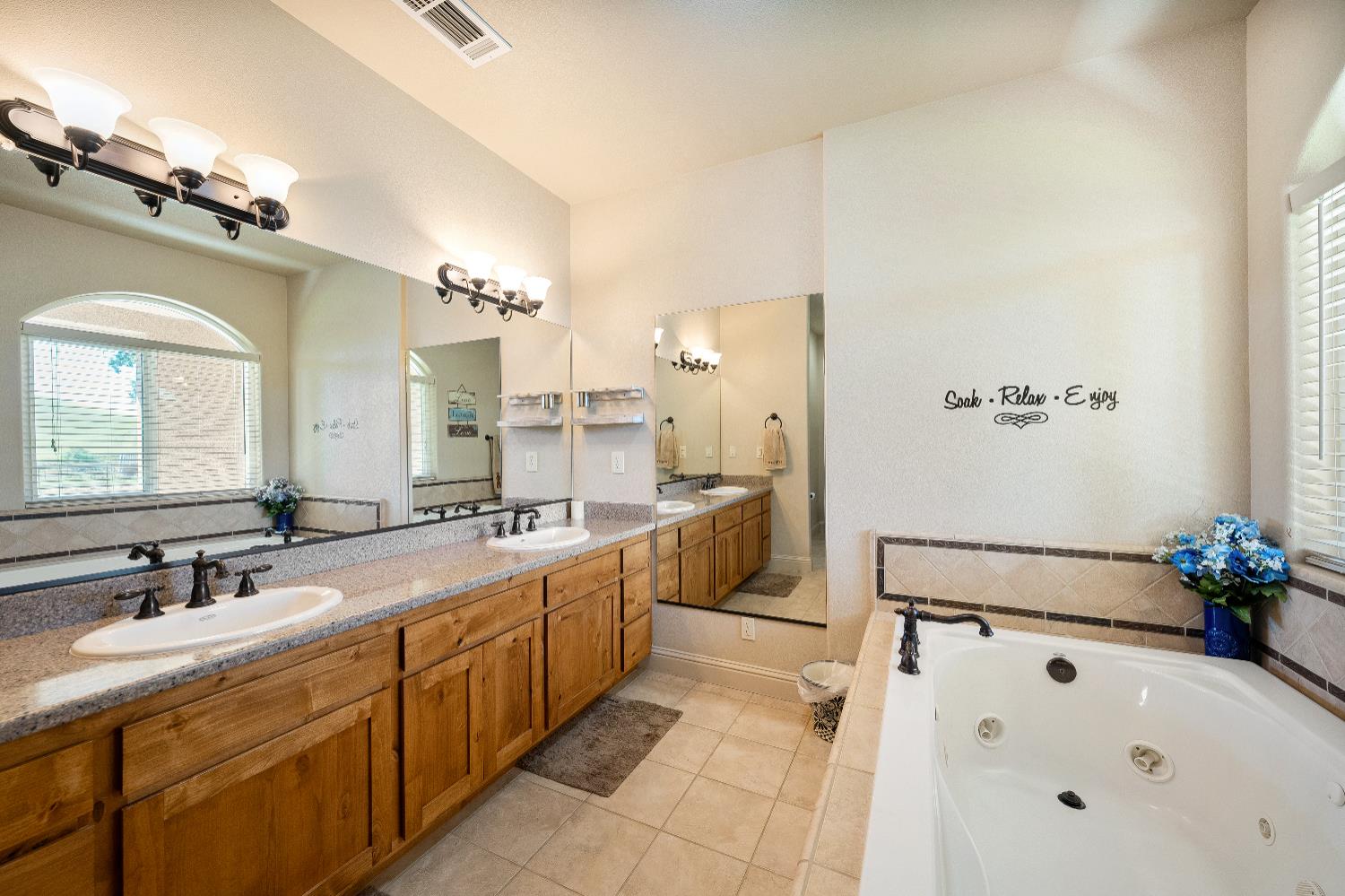 15605 Johnson Road Red Bluff, CA 96080 - Photo 23 of 88 a spacious bathroom with a double vanity sink a large mirror and a bathtub