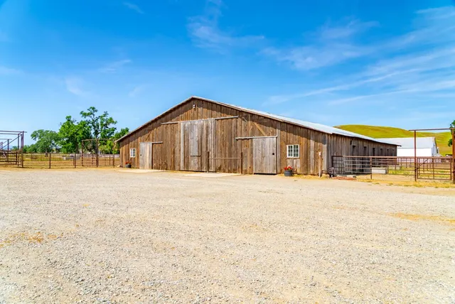 a living room with furniture and floor to ceiling window