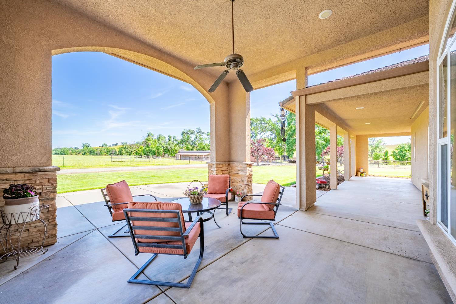 15605 Johnson Road Red Bluff, CA 96080 - Photo 66 of 88 a view of a patio with a table chairs and a floor to ceiling window