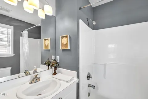 a bathroom with a sink a mirror and a shower