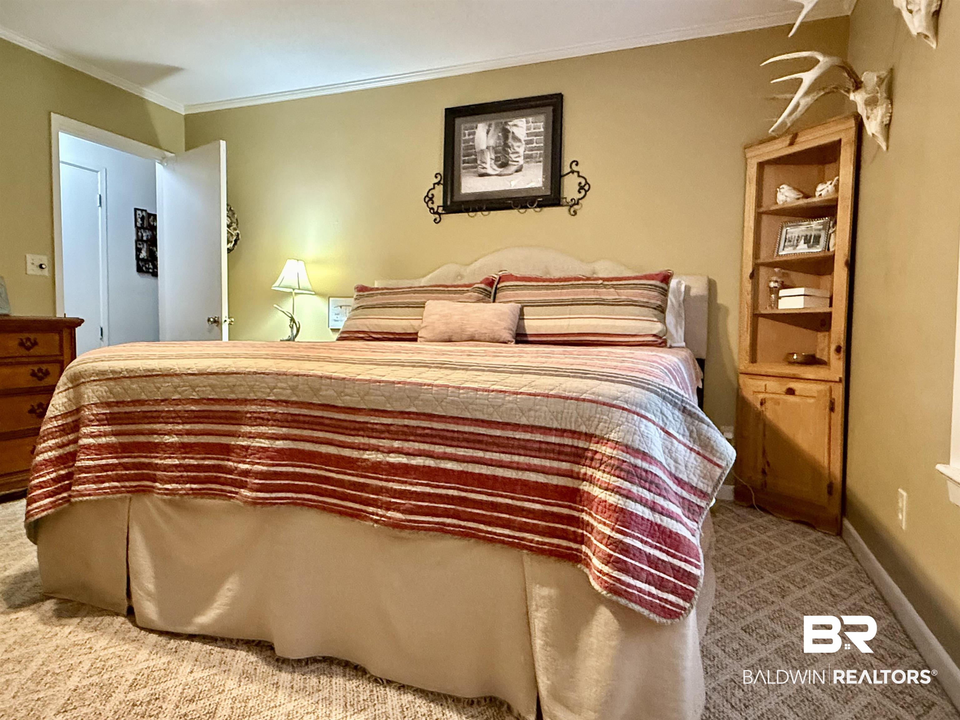 5971 Appleton Road Brewton, AL 36426 - Photo 11 of 23 Carpeted bedroom featuring ornamental molding and baseboards