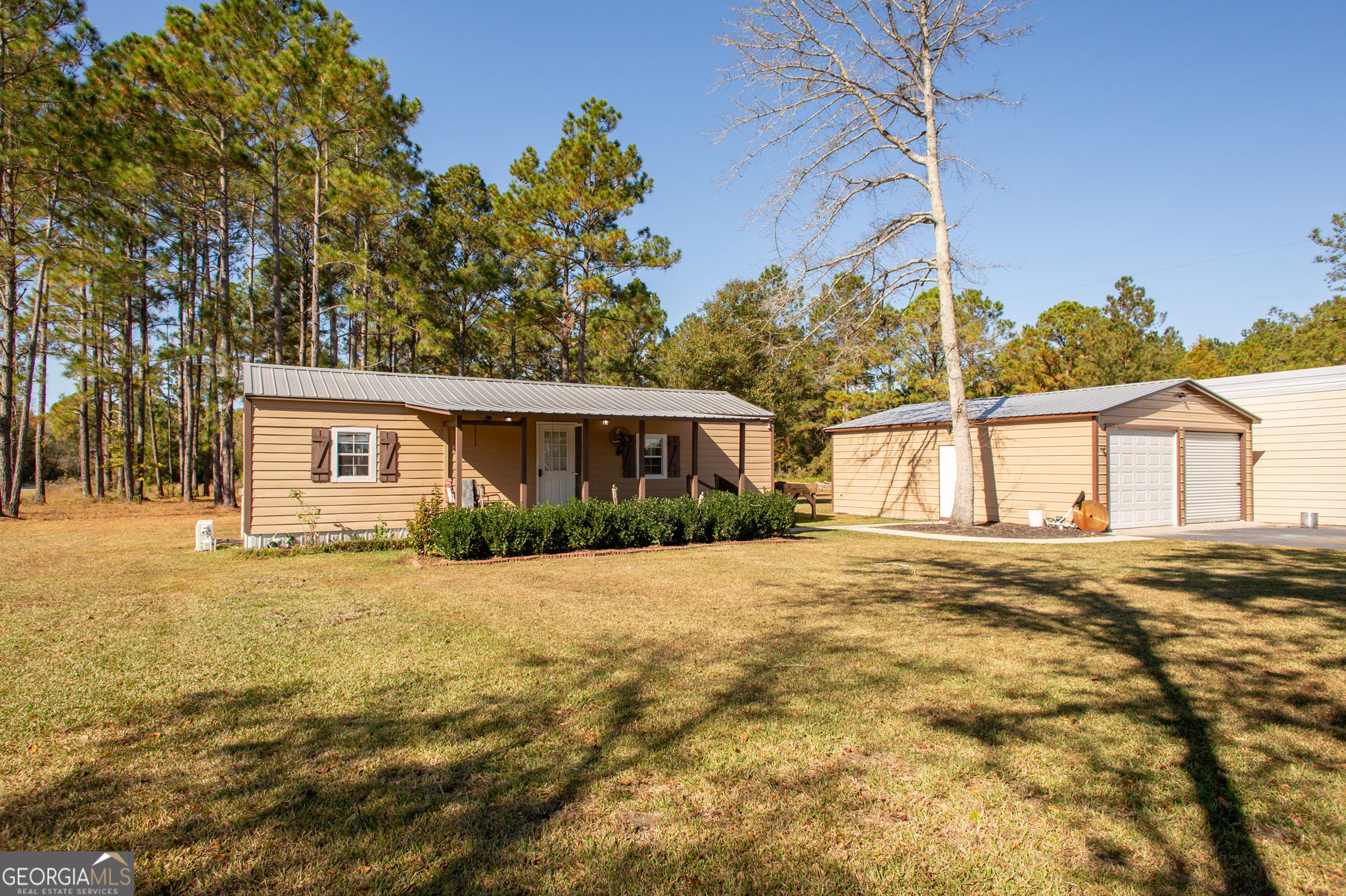 a front view of a house with a garden