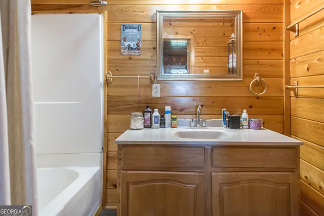 a bathroom with a sink a toilet and shower curtain