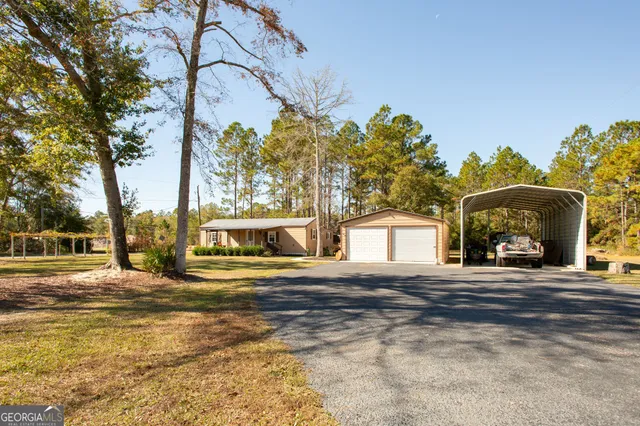 a view of a house with a yard and garage