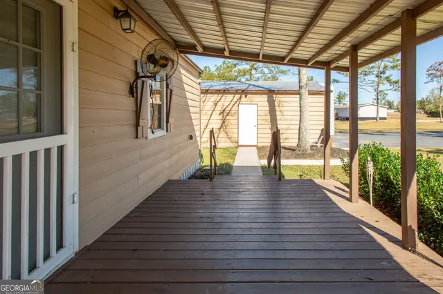 a view of empty room with wooden floor and floor to ceiling window
