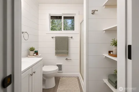 a bathroom with a toilet and a shower