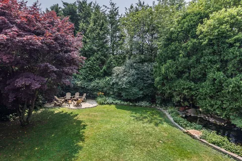 a view of a backyard with swimming pool