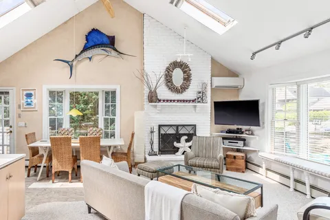 a living room with furniture a flat screen tv and a fireplace