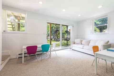 a living room with furniture and a floor to ceiling window