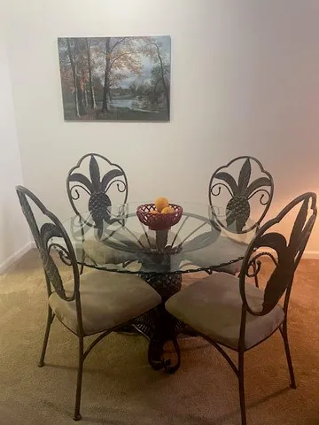 a view of a dinning room with table chairs