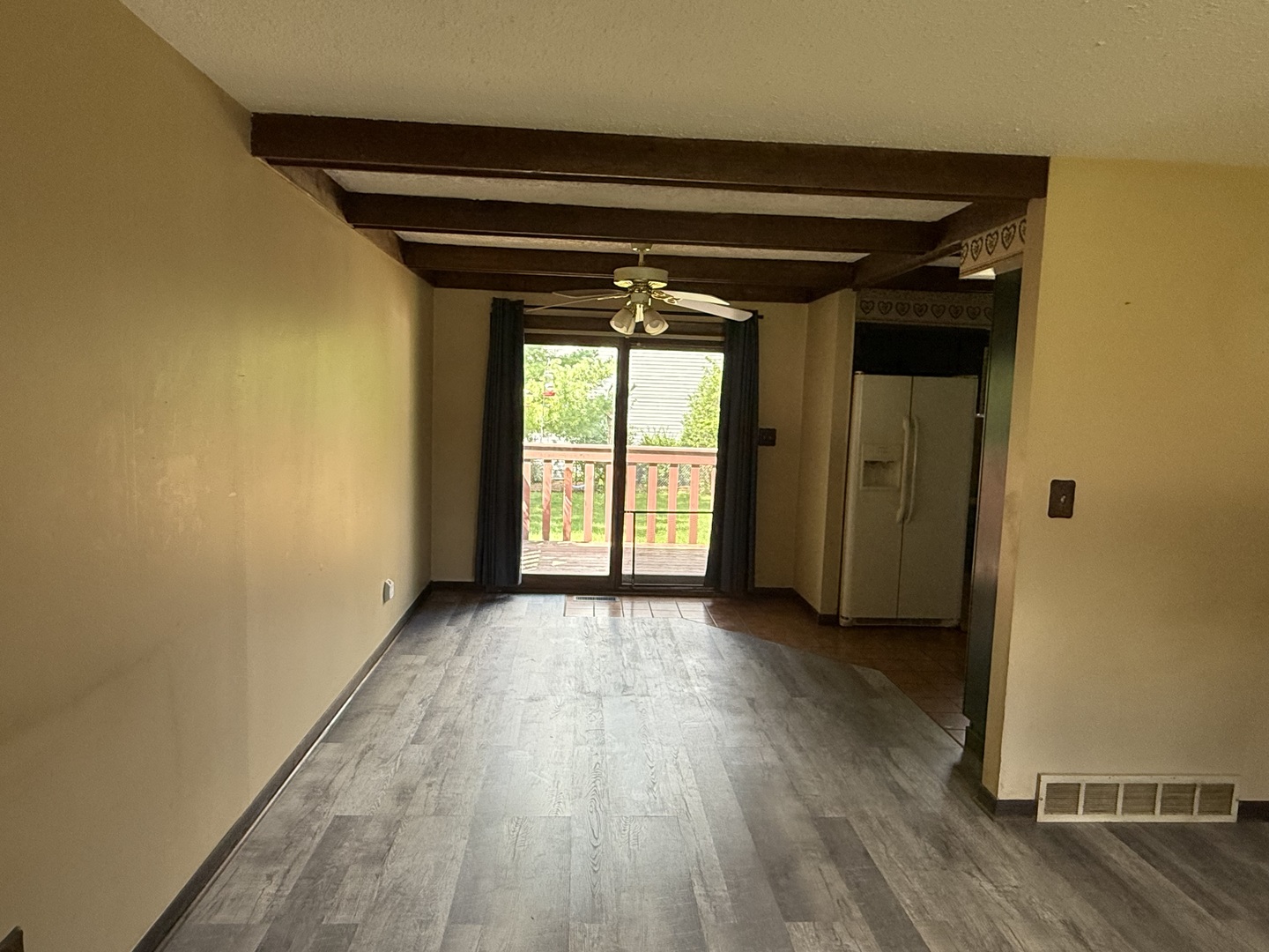 7503 Windsor Avenue Spring Grove, IL 60081 - Photo 5 of 14 an empty room with wooden floor and a window