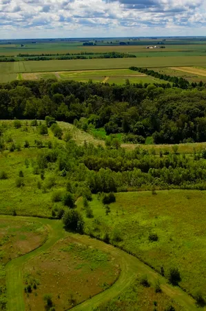 a view of a field with an ocean view