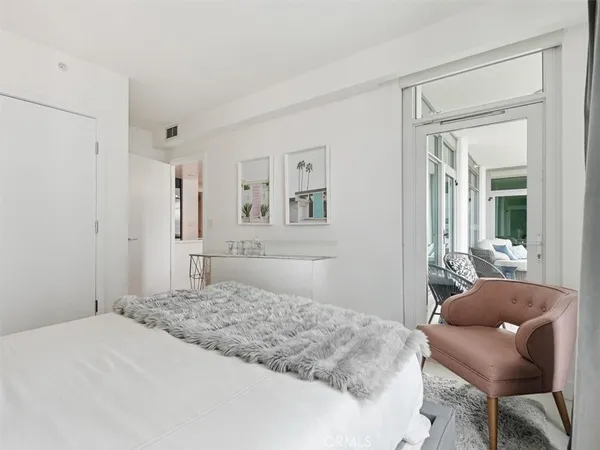 a bedroom with a bed and a chair