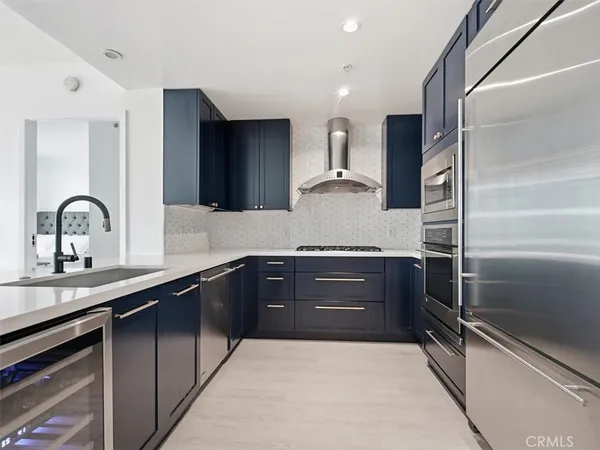 a kitchen with a sink and stainless steel appliances