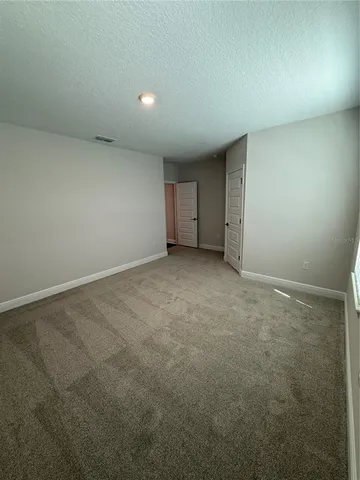 an empty room with a empty space and windows