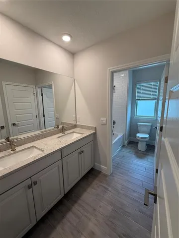 a spacious bathroom with a double vanity sink and a mirror