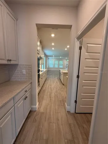 a view of a kitchen with wooden floor and stairs