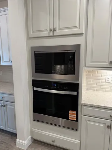a stove top oven sitting inside of a kitchen