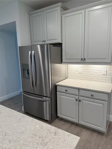 a kitchen with cabinets and stainless steel appliances