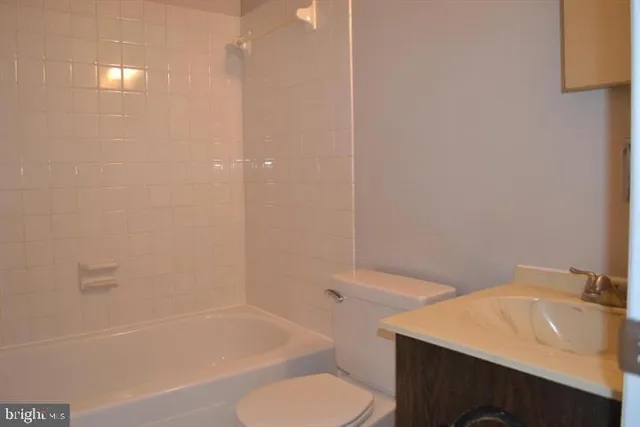 a bathroom with a sink toilet vanity and bathtub