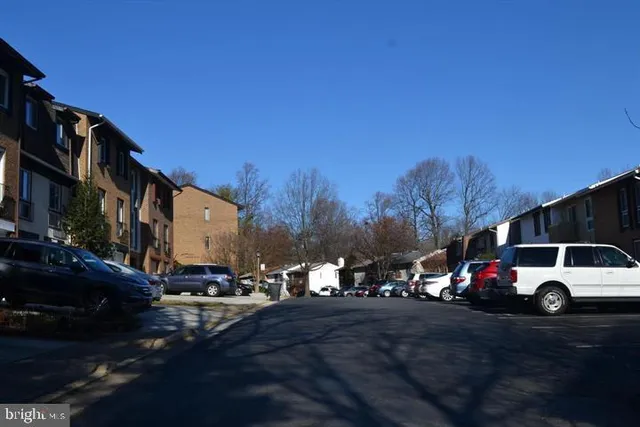 a view of city street with parked cars