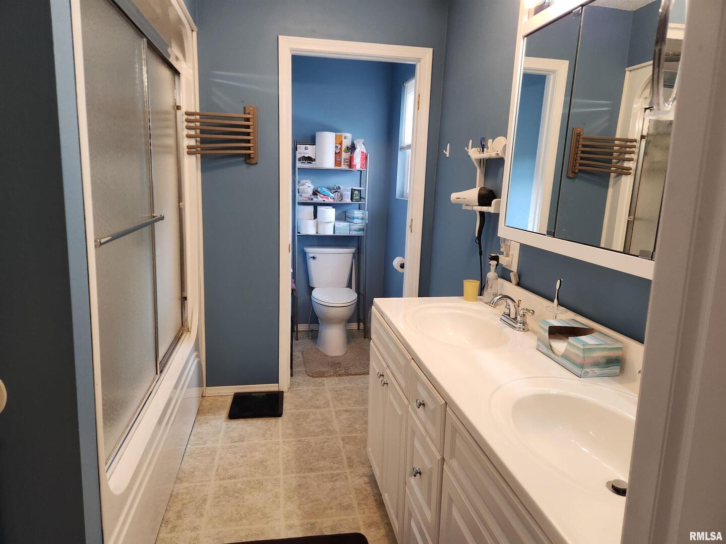 15766 East Tilton Road Ina, IL 62846 - Photo 14 of 59 a bathroom with a sink a toilet and shower