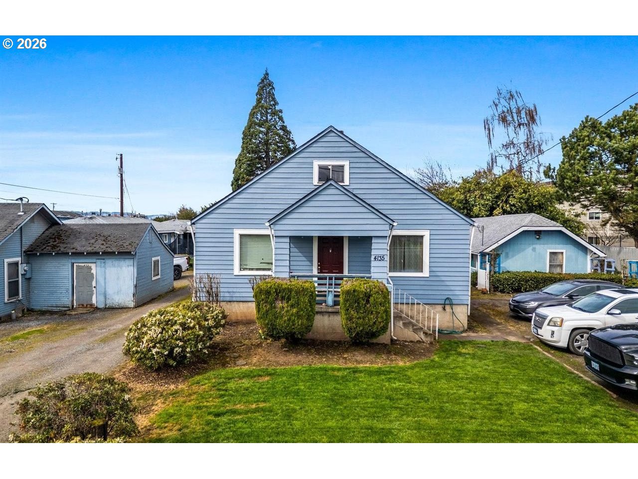a front view of a house with a garden