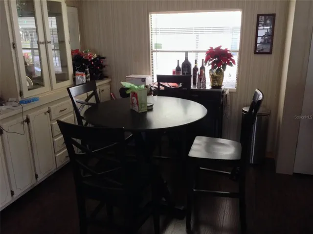 a dining room with furniture and wooden floor
