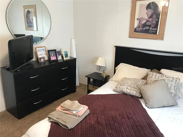 a bed room with a bed and a mirror