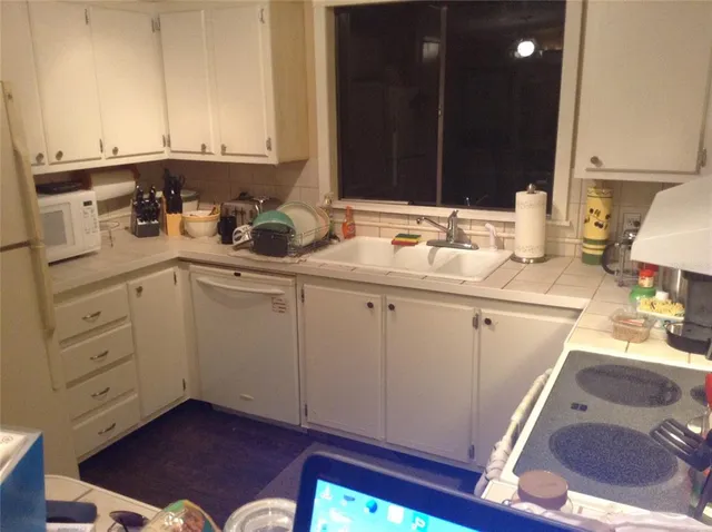 a kitchen with a sink cabinets and appliances