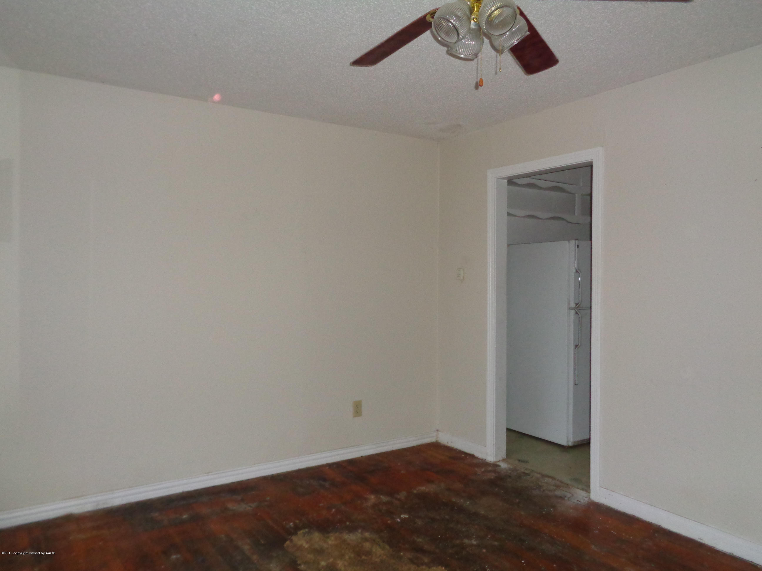 4345 South Tyler Street Amarillo, TX 79110 - Photo 3 of 10 an empty room with a ceiling fan and wooden floor