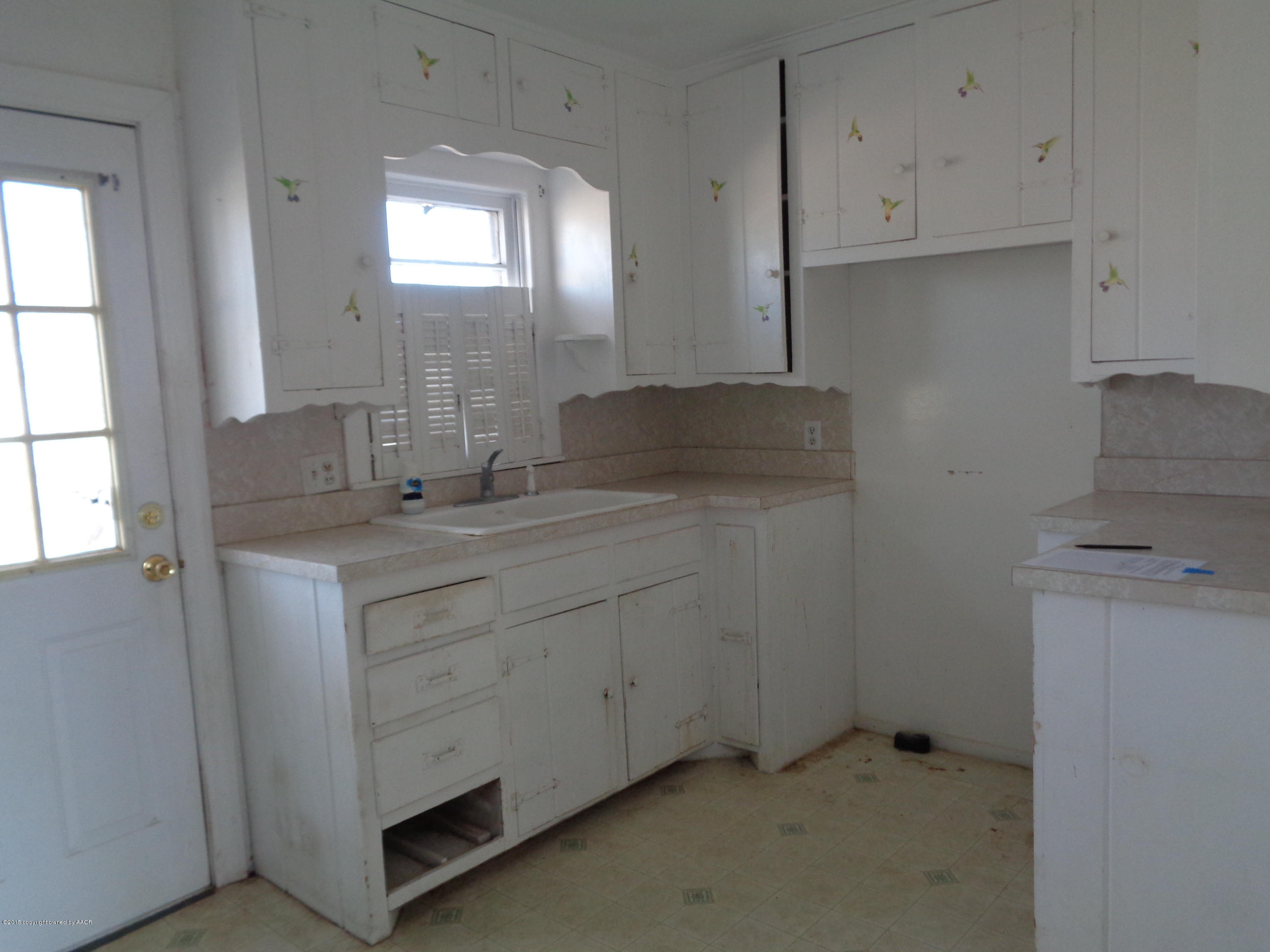 4345 South Tyler Street Amarillo, TX 79110 - Photo 4 of 10 a bathroom with a granite countertop sink and a mirror