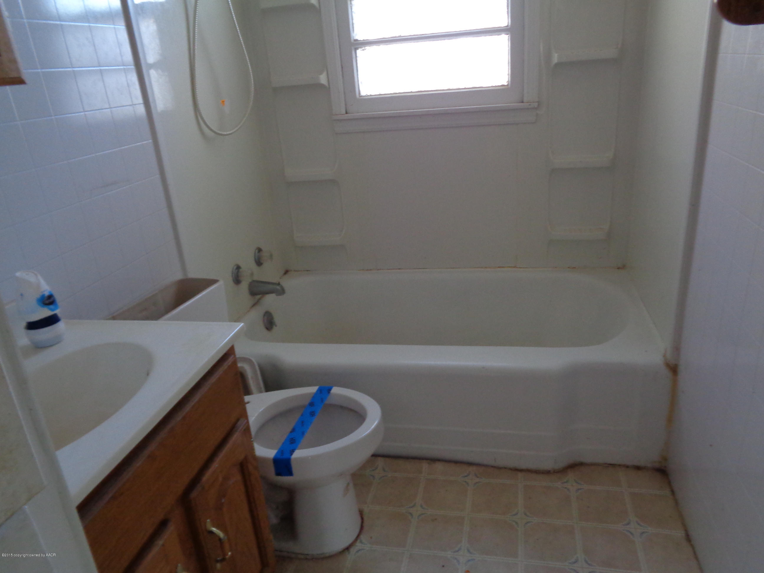 4345 South Tyler Street Amarillo, TX 79110 - Photo 8 of 10 a bathroom with a sink and bathtub with toilet