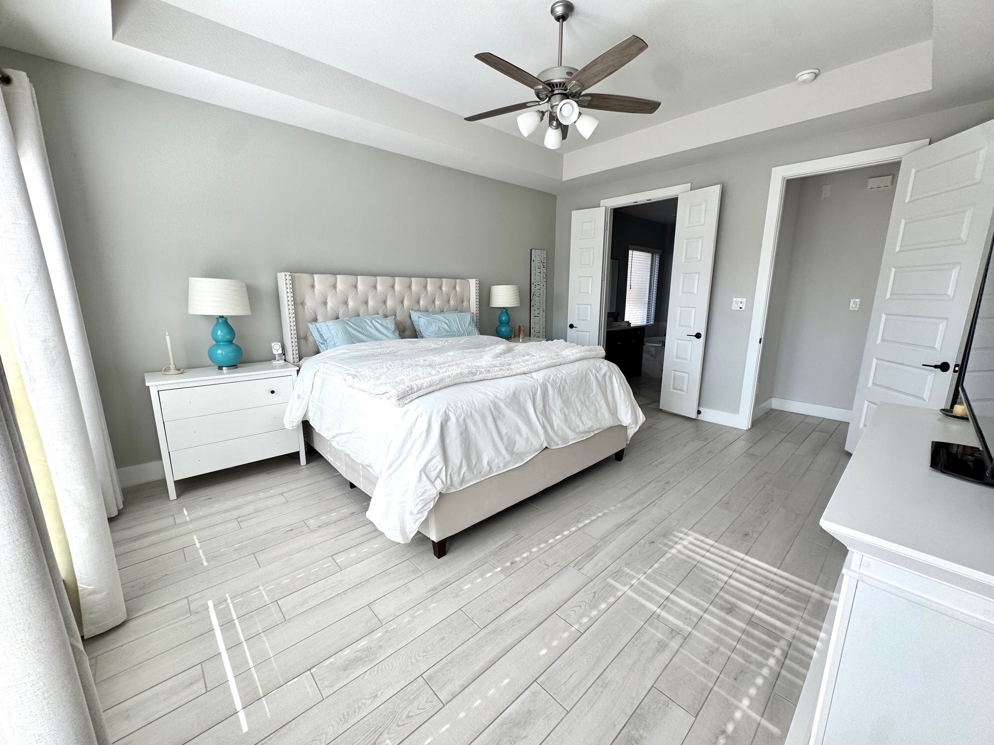 561 Cold Riv Run Kyle, TX 78640 - Photo 7 of 33 a bedroom with a large bed a flat tv screen and dresser