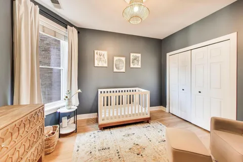 a bedroom with furniture and baby crib