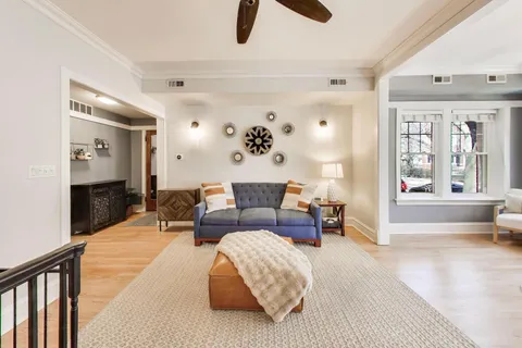 a living room with furniture and a wooden floor
