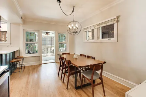 a view of a dining room with furniture wooden floor and a chandelier