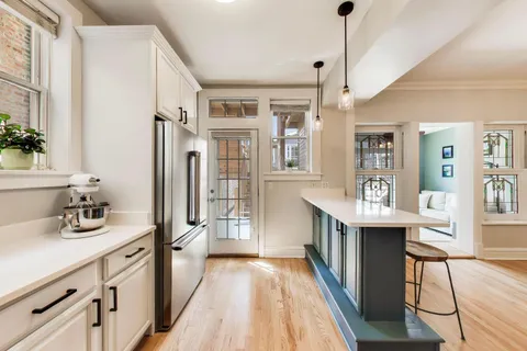 a kitchen with white cabinets and white appliances