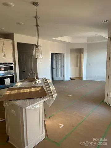 a kitchen with kitchen island a counter top a stove a sink and a refrigerator