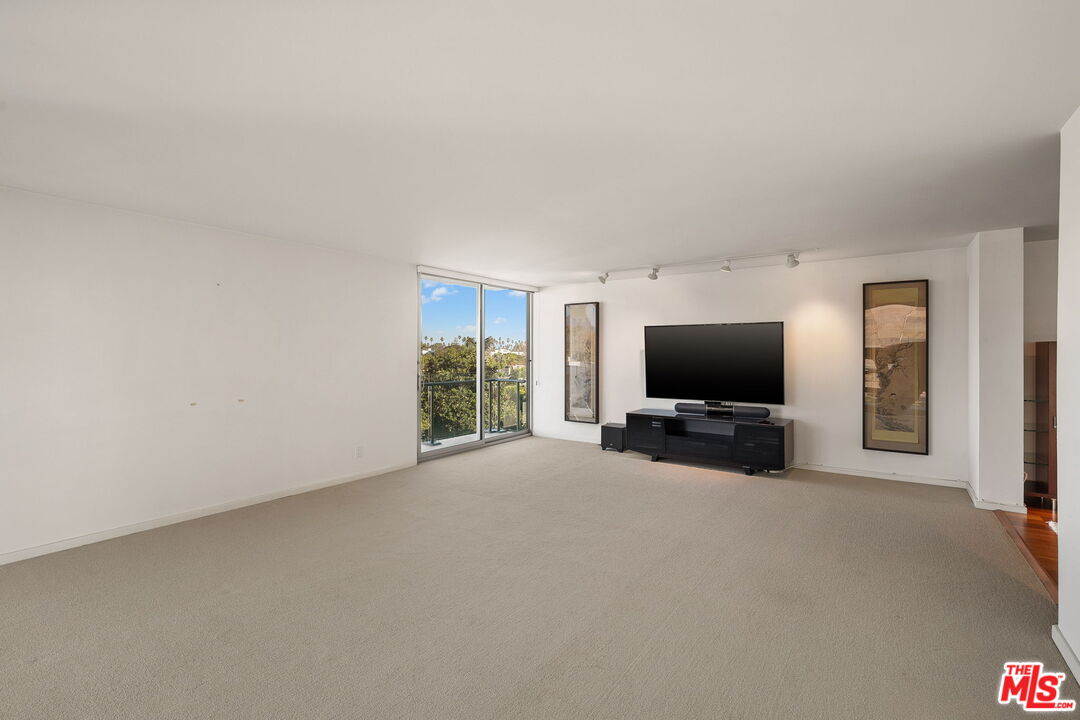 535 Ocean Avenue, Unit 5C Santa Monica, CA 90402 - Photo 12 of 29 a view of a livingroom with a flat screen tv and a window