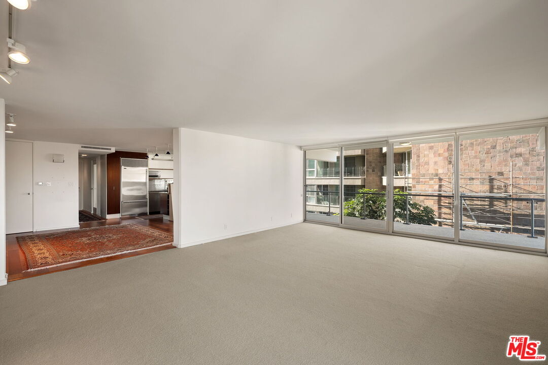 535 Ocean Avenue, Unit 5C Santa Monica, CA 90402 - Photo 14 of 29 a view of a big room with windows and chandelier fan