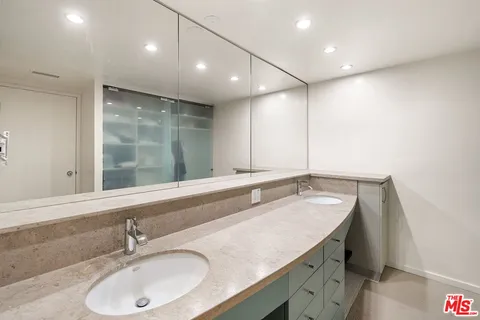 a bathroom with a sink double vanity and shower