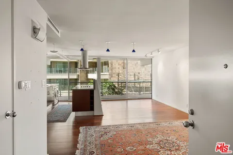 a view of a living room with hardwood floor and a floor to ceiling window