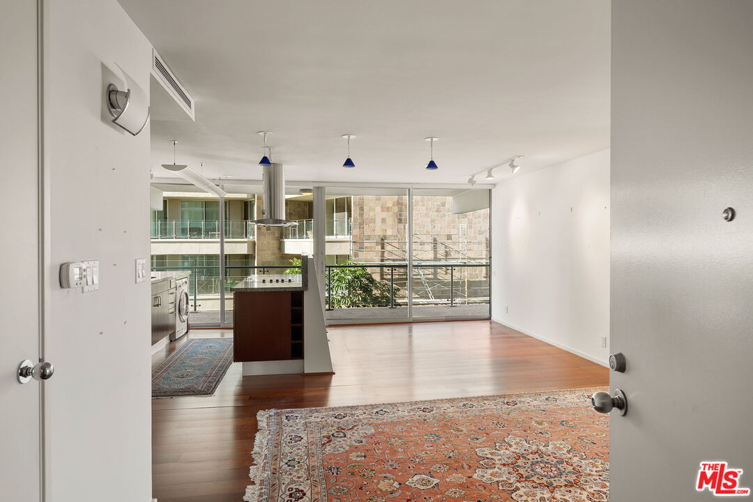 535 Ocean Avenue, Unit 5C Santa Monica, CA 90402 - Photo 3 of 29 a view of a living room with hardwood floor and a floor to ceiling window