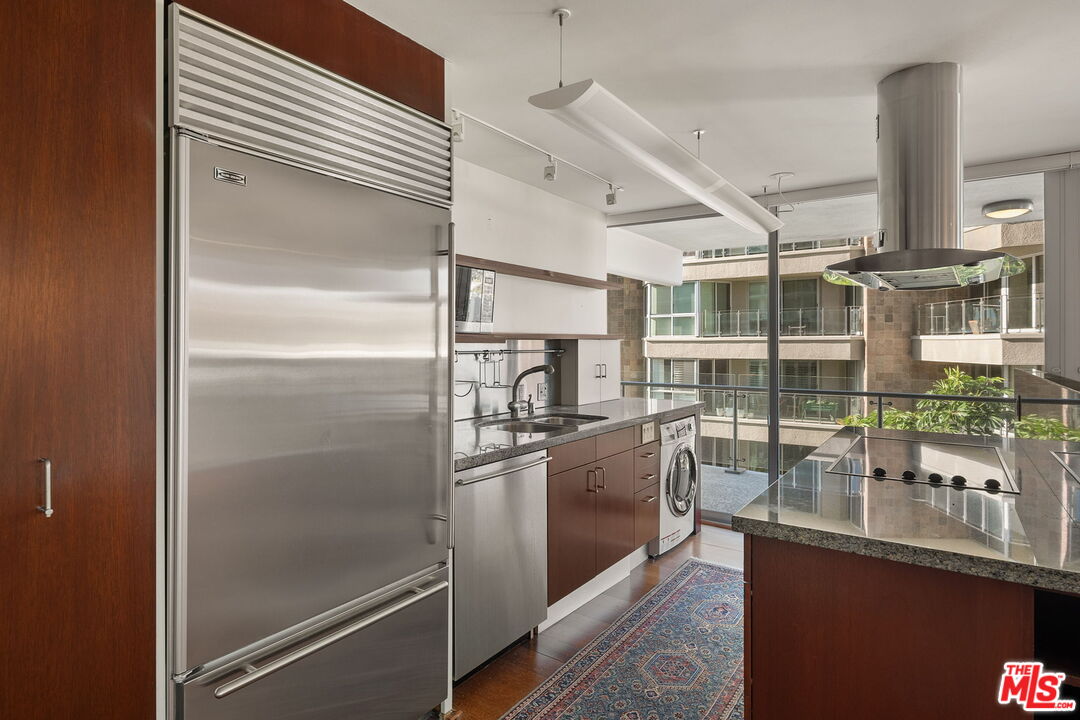535 Ocean Avenue, Unit 5C Santa Monica, CA 90402 - Photo 5 of 29 a kitchen with counter top space and stainless steel appliances