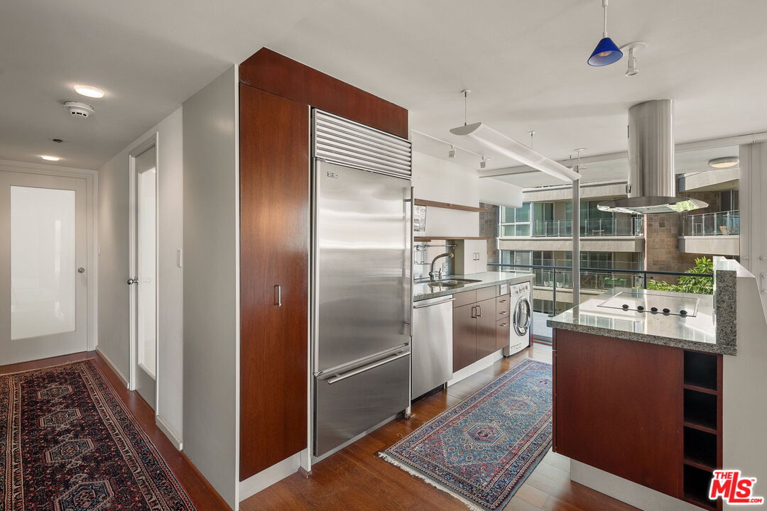 535 Ocean Avenue, Unit 5C Santa Monica, CA 90402 - Photo 6 of 29 a kitchen with stainless steel appliances granite countertop a refrigerator and a stove