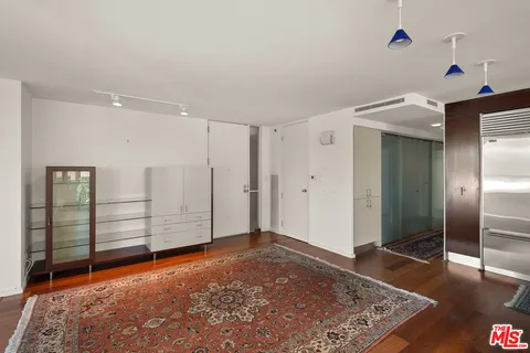 a view of livingroom with hallway and wooden floor