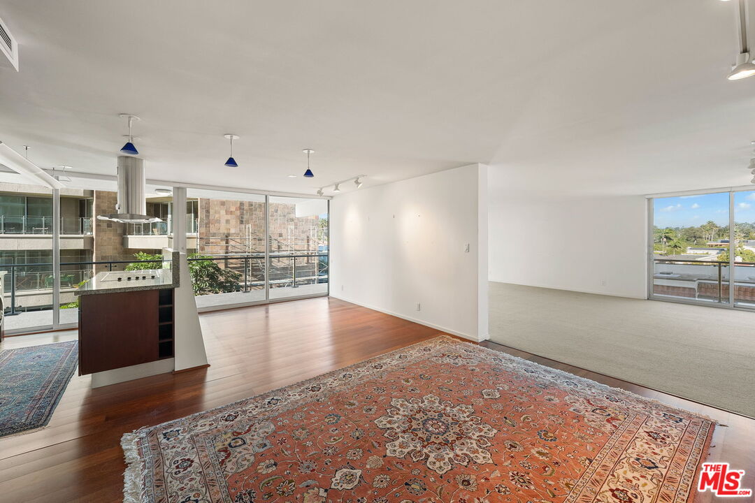 535 Ocean Avenue, Unit 5C Santa Monica, CA 90402 - Photo 10 of 29 a view of a living room hardwood floor and a kitchen