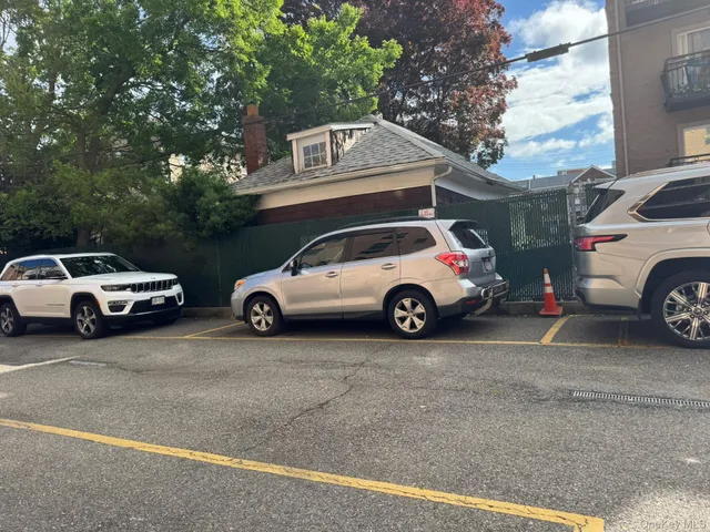 a view of a car parked in front of a house