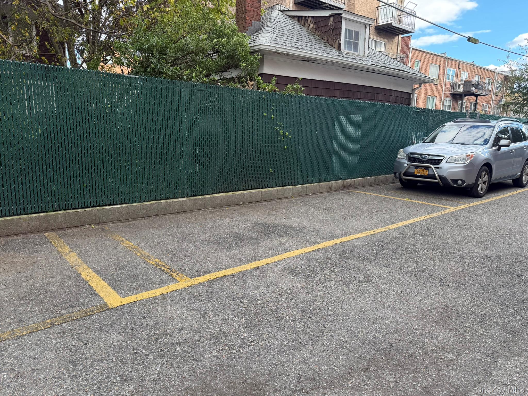 42-23 212th Street, Unit 3C Queens, NY 11361 - Photo 12 of 13 View of uncovered parking lot